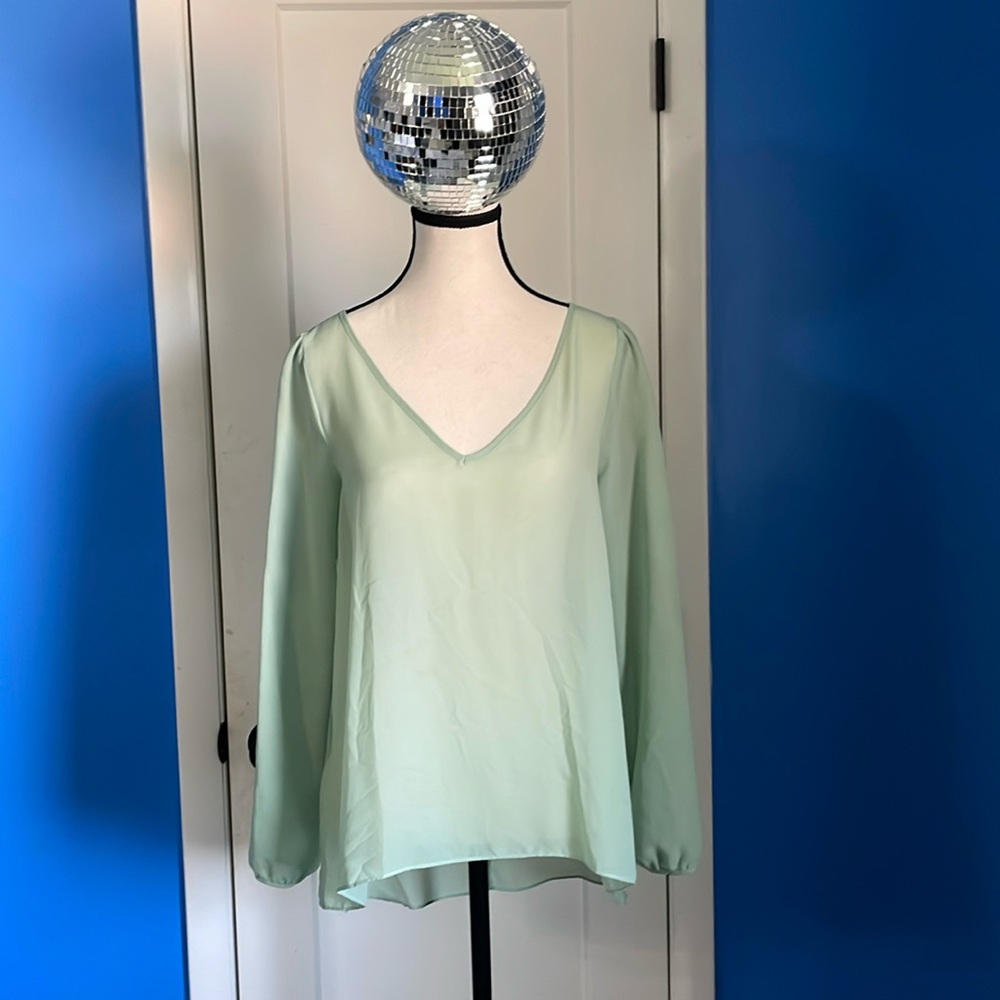 BCBG seafoam green blouse w/open triangle cut out back. Tuxedo back length